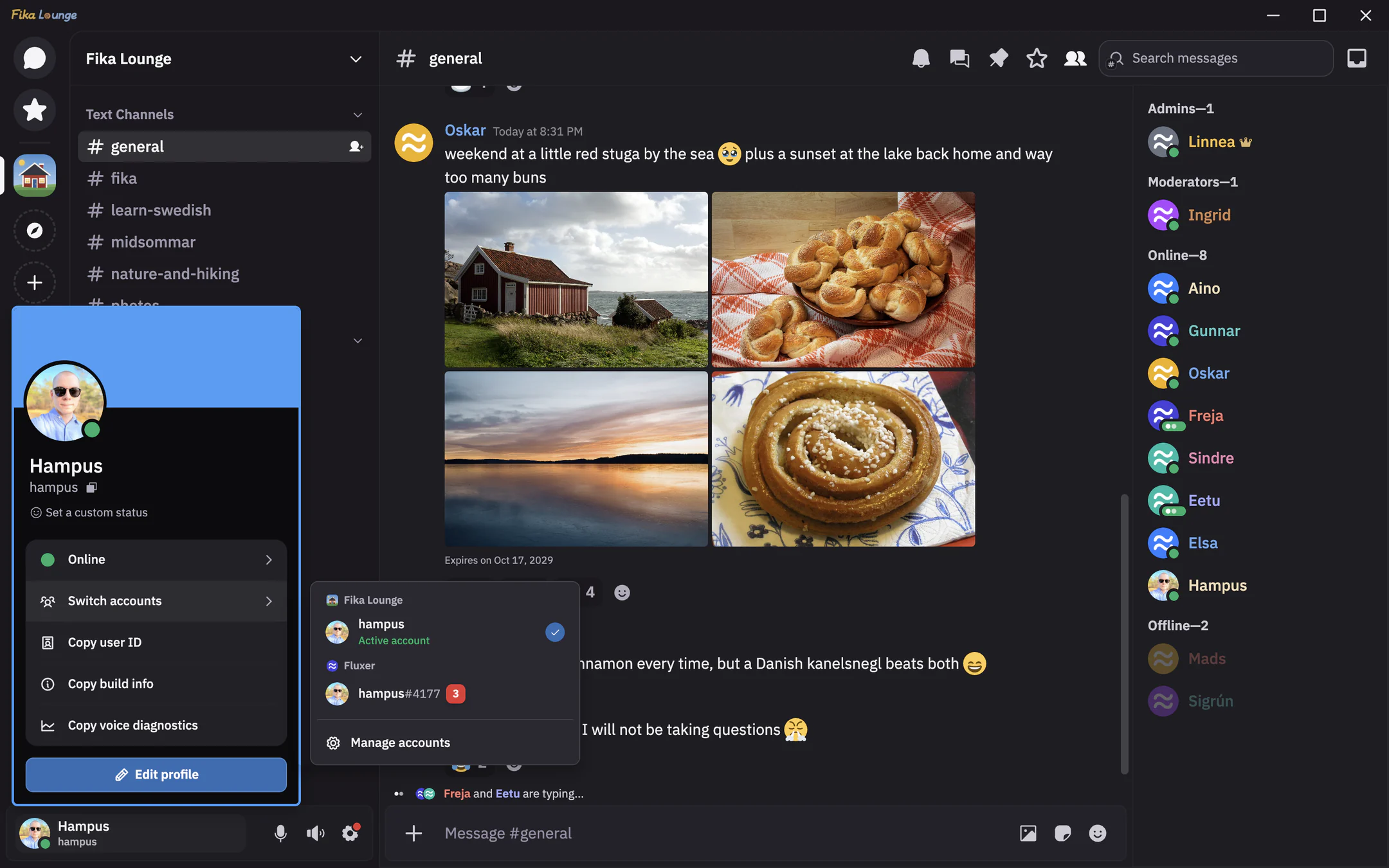 The desktop app on Windows in the general channel of Fika Lounge, with the Fika Lounge logo text at the top left and the window controls at the top right. The chat shows a message from Oskar with four photos, a red cottage by the sea, a tray of cardamom buns, a sunset over a lake and a cinnamon bun, then messages from Freja and Elsa about cinnamon buns, and Freja and Eetu are typing. The member list groups people under Admins, Moderators, Online and Offline. Hampus's profile menu is open with the Switch accounts menu next to it, showing the active account under Fika Lounge and an account under Fluxer with a badge of 3